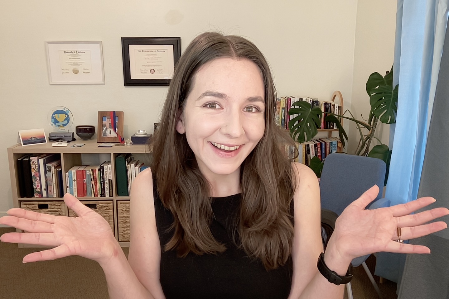 Joan smiling with open hands, welcoming you